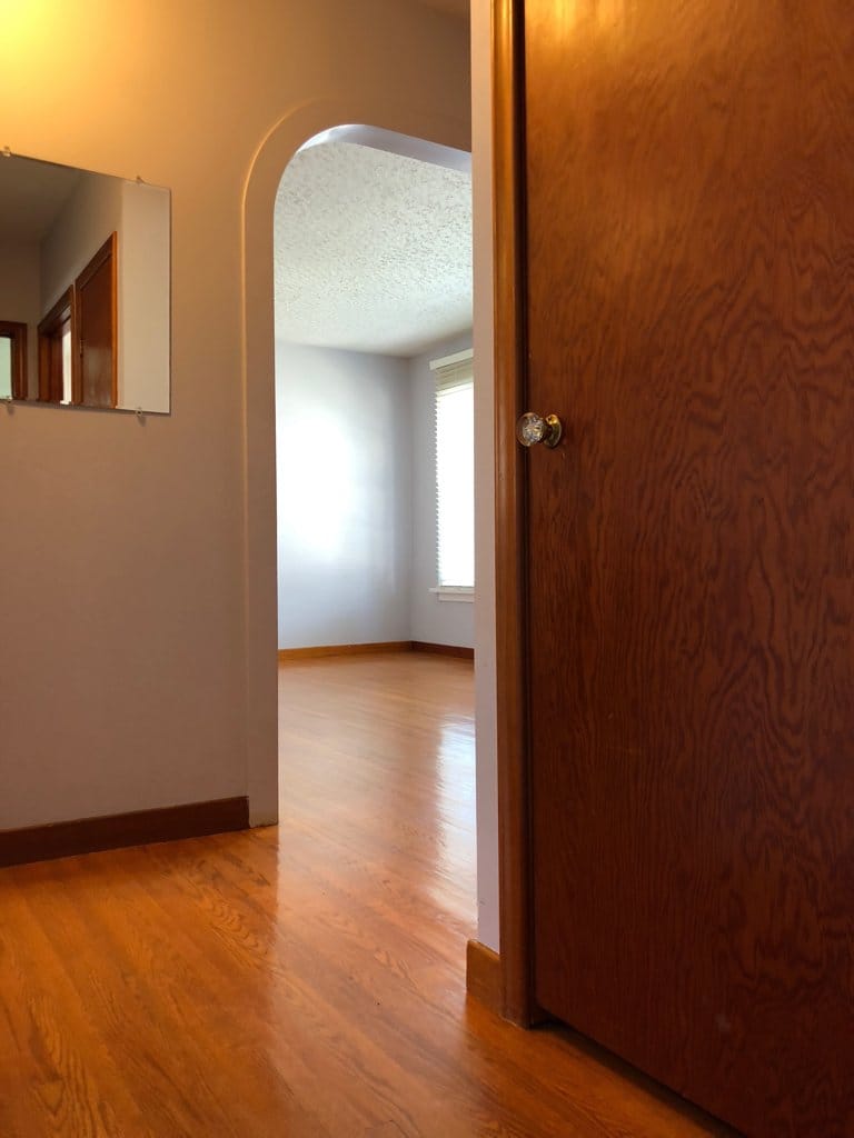 The door on the right is a linen | broom closet.  You are looking into the living room, the kitchen is to the left, front entry to the right.