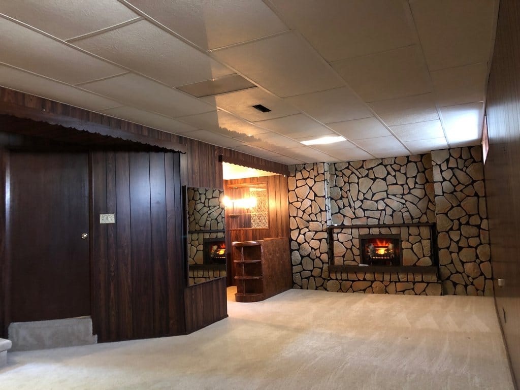 Man cave with faux fireplace, which doubles as an electric heater.